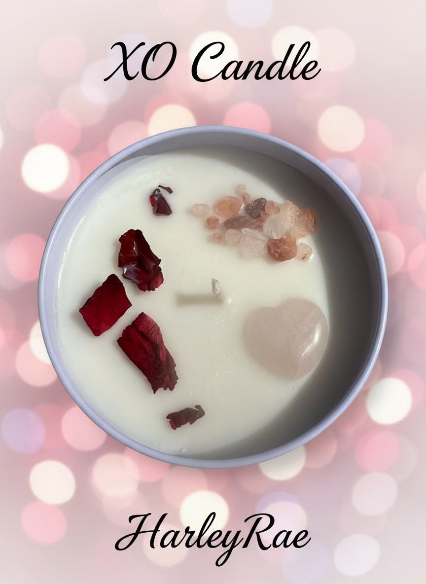Candle with visible wicks and debris in a bowl with 'XO Candle' and 'HarleyRae' text on a blurred light background.