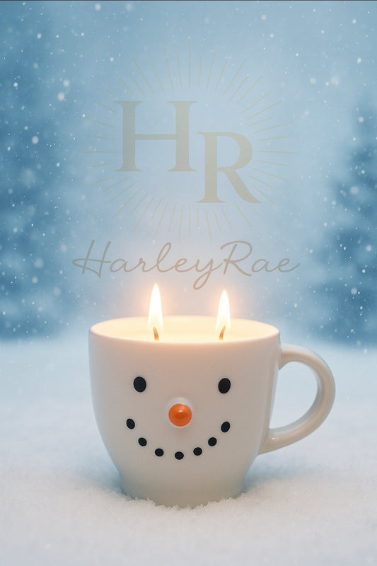 Snowman-shaped candle with Toasted Marshmallow Scent in a mug with 'HR HarleyRae' branding against a snowy background.