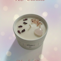 XO Candle in a white container with decorative elements on a light surface